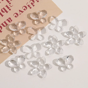 Close-up of clear acrylic butterfly and flower charms with holes for DIY jewelry making