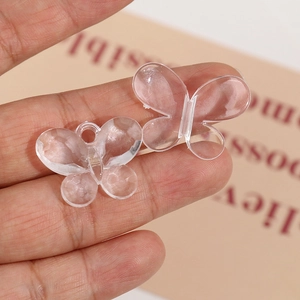 Transparent butterfly acrylic charms for DIY jewelry making held in hand for size