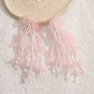 Detail of pink resin flower petals and long beaded tassels on stylish drop earrings