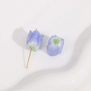 Macro detail of glitter purple acrylic rose bead with a gold metal pin for DIY jewelry