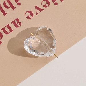 Macro detail of a transparent faceted heart-shaped bead for DIY jewelry making