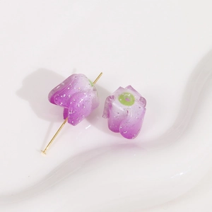 Macro detail of purple glitter flower charms with golden metal pin for DIY jewelry making