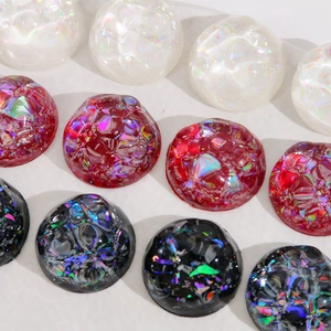 Macro view of 20mm AB resin cabochons with laser foil and wavy surface texture