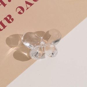 Detailed view of a transparent butterfly-shaped acrylic bead for DIY jewelry and hair accessories