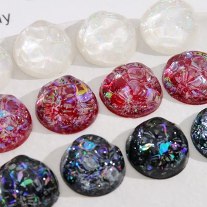 Macro shot of 20mm round AB gradient resin cabochons with iridescent shell foil texture