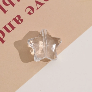 Macro shot of clear faceted star-shaped acrylic bead with vertical hole for DIY jewelry