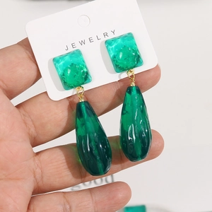 Detail of emerald green translucent square and teardrop resin earrings with wave texture