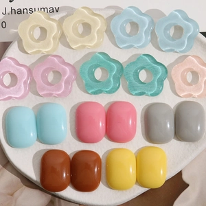 Close-up of pastel resin flower and oval cabochons for DIY jewelry making and crafts