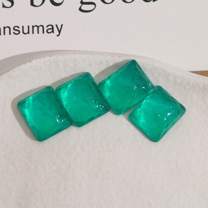 Translucent emerald green square resin earrings with irregular textured surface and rounded edges