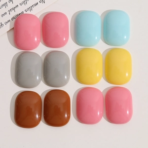 Flat lay of colorful oval resin charms in candy colors for DIY jewelry and crafts