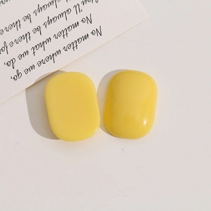 Detailed macro view of yellow rectangular resin charms for DIY jewelry and hair accessories