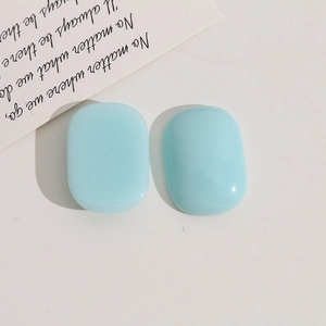 Detail of light blue oval resin cabochons for DIY jewelry and hair accessories