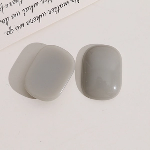 Close-up of polished gray oval resin charms for DIY jewelry and earring accessories