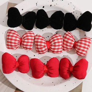 Detail view of 9-piece soft fabric bow hair accessories in plaid and solid patterns
