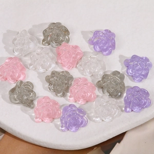 Macro detail of translucent resin flower charms in pink, purple and white for DIY jewelry