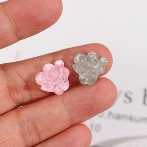 Macro shot of 3D resin flower charms in translucent pink and smoke grey for DIY jewelry