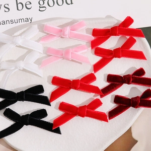 Detailed view of handmade velvet ribbon bows in multiple colors for DIY jewelry crafts