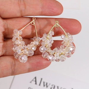 Detail of handmade gold teardrop crystal charms featuring wire-wrapped faceted glass beads