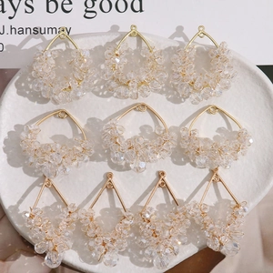 Macro view of handmade crystal beaded pendants in gold geometric frames for DIY jewelry