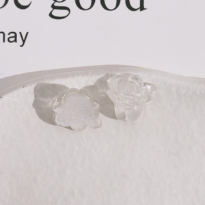 Close-up of translucent pink resin floral charms for DIY earrings and jewelry making