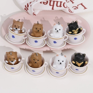 Set of eight miniature puppy figurines in white coffee cups with metal ring hooks