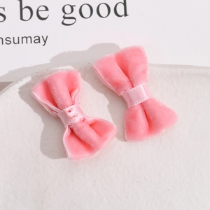 Close-up of pink velvet handmade bow hair clips with soft texture for DIY accessories
