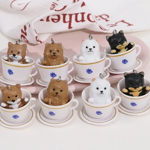 Detailed view of assorted miniature teacup dog charms in resin on a pink tray