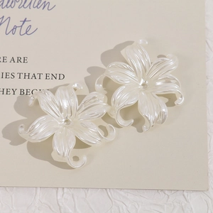 Detail of pearl white irregular flower beads with center holes for DIY jewelry making