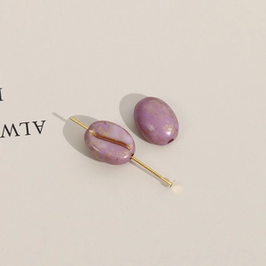 Detail van paarse ovale acryl kraal met gouden vlekken voor DIY sieraden maken