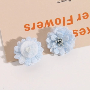 Detailed view of handmade light blue mesh flower accessory with layered petals and soft core