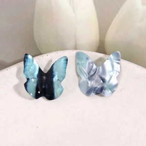 Macro view of 3D resin butterfly charms with metallic texture for DIY jewelry making