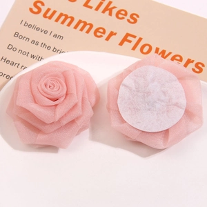 Detail of pink mesh rose fabric flowers with multi-layered petals and white felt backing