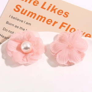 Detailed view of pink mesh camellia flowers with pearls for DIY hair accessories