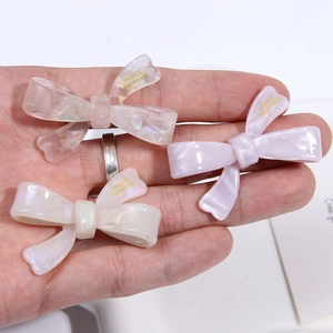 Three acetate bow hair clips in cream colors with France Handmade gold engraving