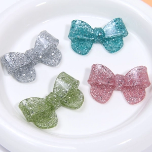 Glitter resin bow tie accessories in four pastel colors for DIY hair clips and decor