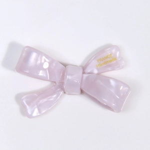Close-up of lilac acetate bow hair clip with gold France Handmade lettering