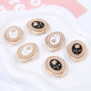 Detailed view of vintage gold rose buttons with pearl accents and enamel finish