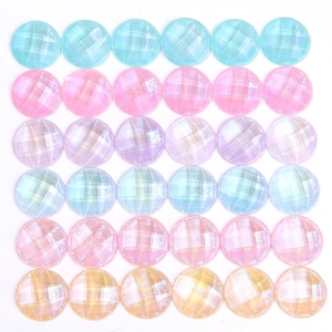 Detailed view of round faceted resin charms with glitter finish in multiple colors