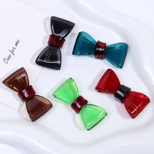 Detail of five-color acetate bow hair accessories with gold France Handmade lettering