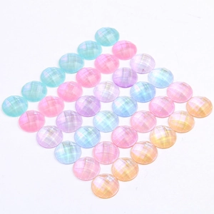 Detailed macro view of faceted iridescent resin half-round beads with glitter finish