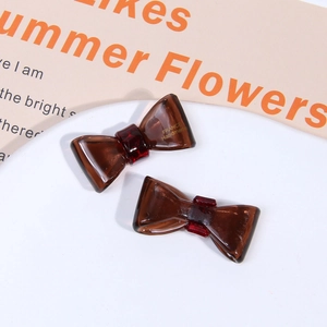 Detailed shot of two tortoiseshell acetate bow hair clips with France handmade lettering