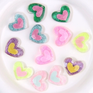 Dettaglio di ciondoli a cuore in resina glitterata per gioielli e accessori fai-da-te