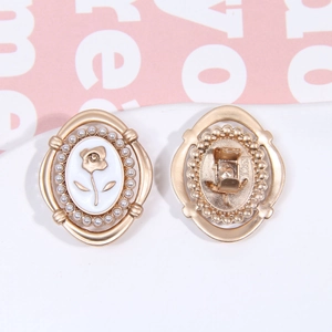 Detailed front and back view of a vintage gold rose earring with pearl edging and enamel