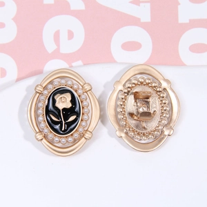 Macro detail of vintage alloy rose earrings with black enamel and pearl inlay