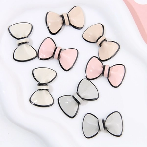 Close-up of Morandi colored acetate bow charms with glossy finish for DIY accessories