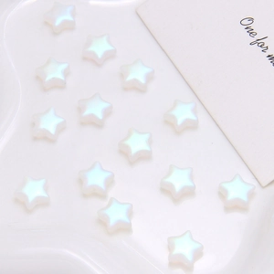 Close-up of aurora finish star-shaped glass beads for DIY jewelry making and crafts