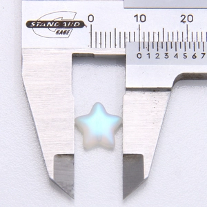 Macro view of 10mm moonstone star bead measured with a caliper for DIY jewelry