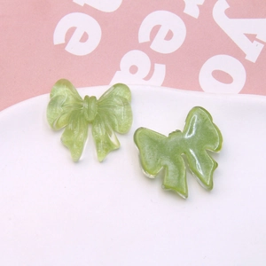 Detailed view of translucent resin bow accessories for DIY hairpins and jewelry