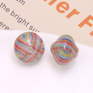 Macro shot of two vintage oil painting style colorful striped resin beads for DIY jewelry
