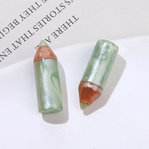 Pearlescent green resin pencil-shaped DIY charm with orange tip and marble texture